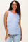 woman wearing a blue and white striped maternity tank top with pink neckline, smiling and standing casually