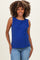 woman wearing a blue sleeveless maternity top and smiling, paired with light blue jeans