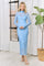 woman wearing a light blue long sleeve sheer dress with white polka dots and a fitted silhouette