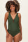 woman wearing a dark green maternity swimsuit with a v-neck and keyhole detail, showing off her baby bump