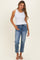 woman wearing a white button-up tank top and blue straight-leg jeans with sandals