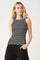 woman wearing a black and white striped sleeveless top with a fitted style and casual black pants
