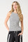woman wearing a black and white striped tank top with a high neckline and relaxed fit shorts
