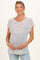 woman wearing a striped white maternity top with short sleeves and holding her baby bump