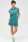 woman wearing a teal short sleeve mini dress with a zip neckline and side slits, styled casually with sneakers