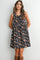 woman wearing a navy floral print sleeveless dress with a gathered skirt and adjustable drawstring neckline