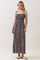 woman wearing a navy floral maxi dress with adjustable straps and a smocked bodice