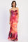 woman wearing a sleeveless pink tie-front maxi dress with an artistic floral print