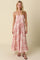 woman wearing a floral print maxi dress in pink and orange with spaghetti straps