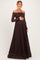 woman wearing a dark brown off-the-shoulder lace maternity gown and holding her baby bump