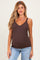 woman wearing a brown maternity tank top with lace trim and a visible baby bump, paired with light wash jeans