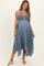 woman wearing a blue maternity dress with a smocked bodice and uneven hemline, showcasing her baby bump
