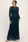 woman wearing a teal lace maternity maxi dress with long sleeves and a fitted silhouette, showcasing her baby bump