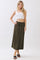 woman wearing an olive green maxi skirt with an elastic waistband and drawstring, paired with a white cropped tank top