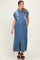 woman wearing a light blue denim button-up maternity dress with short sleeves and a front slit, standing and smiling