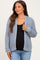 woman wearing a light blue knitted maternity cardigan over a black top and showing her baby bump