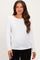 woman wearing a white long sleeve maternity top with a fitted style and visible baby bump