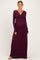 woman wearing a dark purple long sleeve maternity dress with a wrap-style bodice and baby bump visible