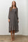 woman wearing a gray floral long sleeve midi dress with a square neckline and ruffled hem