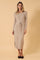 woman wearing a beige ribbed midi dress with long sleeves and a tie waist detail, standing against a light background