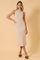 woman wearing a neutral beige sleeveless turtleneck knit midi dress with a relaxed fit and side slits
