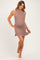 woman wearing a taupe ribbed maternity dress with white trim and a visible baby bump