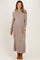 woman wearing a neutral ribbed maternity sweater dress with a half-zip and a visible baby bump