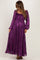 woman wearing a purple floral maternity maxi dress with puff sleeves and a smocked bodice, showcasing her baby bump