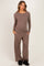 woman wearing a brown maternity long sleeve henley top and matching pants, with a baby bump visible