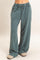 woman wearing teal relaxed fit lounge pants with an elastic waistband and drawstring detail