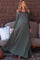 woman wearing an olive green off-shoulder maternity maxi dress with a flowing skirt and a visible baby bump