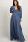 woman wearing a long sleeve blue maternity maxi dress with a wrap front and waist tie