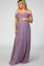 woman wearing a lavender off-the-shoulder maternity gown and holding her baby bump