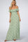 woman wearing a green floral off the shoulder smocked maternity maxi dress