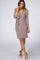 woman wearing a mauve long sleeve maternity wrap dress with a side tie and v-neckline