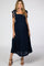 woman wearing a navy blue maternity maxi dress with tie straps and a smocked bodice, showing her baby bump
