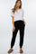 woman wearing a white cropped maternity top and black maternity joggers with pockets