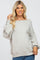 blonde woman wearing a light grey oversized boat neck sweater with balloon sleeves and blue jeans