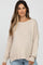 woman wearing a beige oversized knit maternity sweater with a relaxed fit and wide neckline