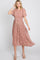 Woman wearing a pink floral midi dress with flutter sleeves and a pleated skirt against a white background