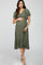 woman wearing an olive green maternity dress with flutter sleeves and a tiered hem, cradling her baby bump