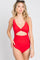 woman wearing a red cut-out one-piece swimsuit with a plunging neckline and ruched details