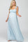 woman wearing a light blue floral maternity maxi dress with ruffled straps and a visible baby bump