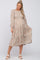 pregnant woman wearing a long sleeve floral tiered maternity midi dress with cream block heel sandals