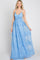 smiling woman wearing a light blue lace maxi dress with spaghetti straps and floral embroidery