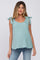 woman wearing a light teal sleeveless maternity top with tie shoulder details and a relaxed fit