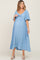 woman wearing a light blue maternity dress with a tie front detail and short flutter sleeves, showcasing her baby bump