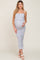 woman wearing a light blue floral maternity dress with ruffles and a visible baby bump