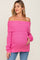 woman wearing a bright pink off-the-shoulder maternity sweater and holding her baby bump
