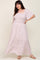 woman wearing a white and pink floral smocked maternity maxi dress with flutter sleeves and square neckline